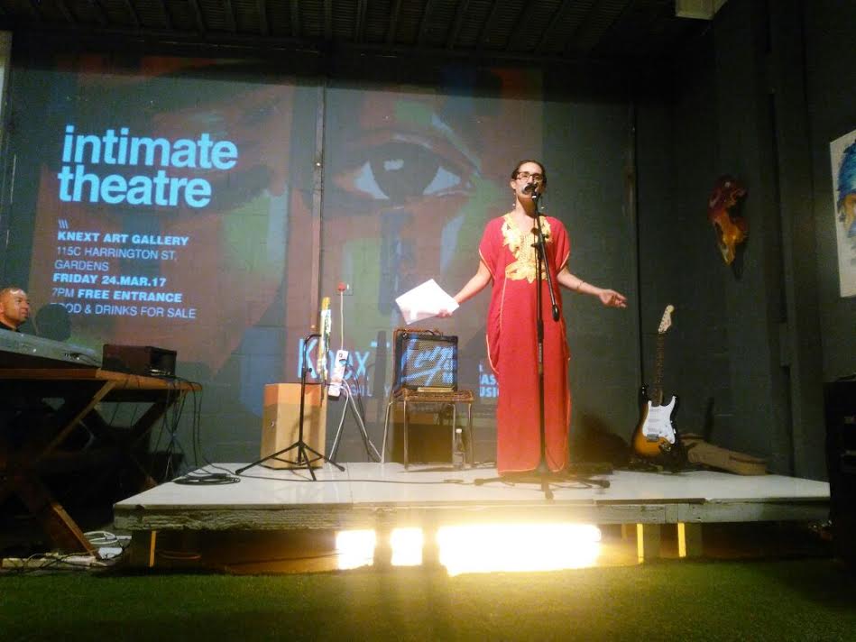 Toby Israel performing spoken-word poetry on stage